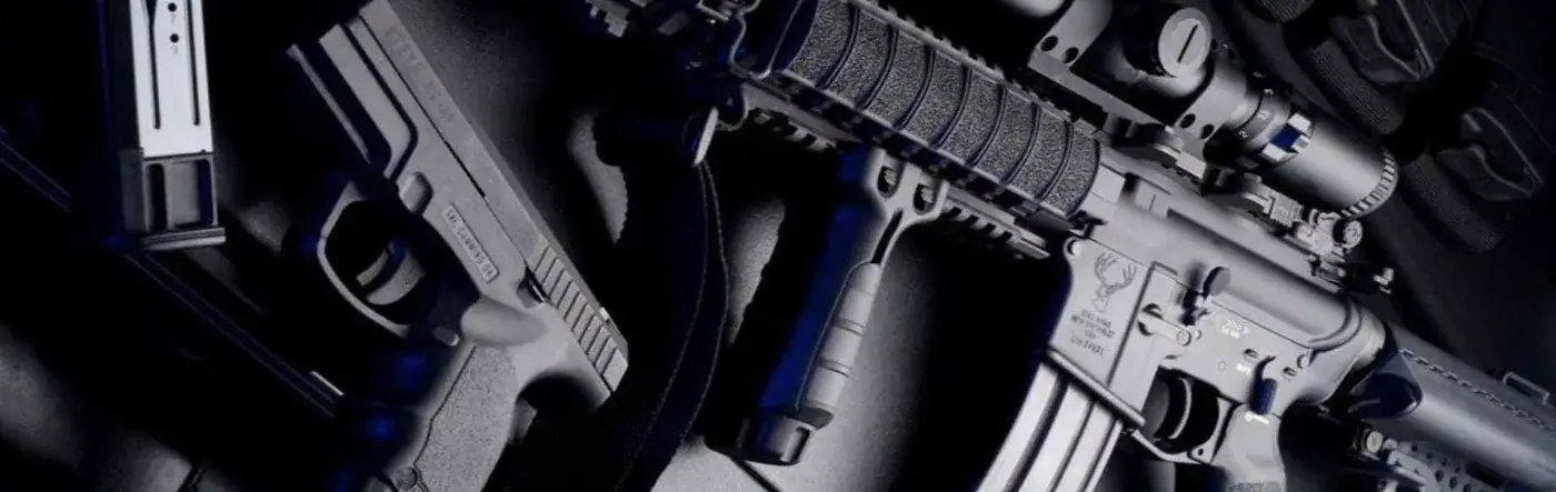 Glock pistol and AR-15 rifle laid out on dark surface — Twin Cities Gun & Pawn contact