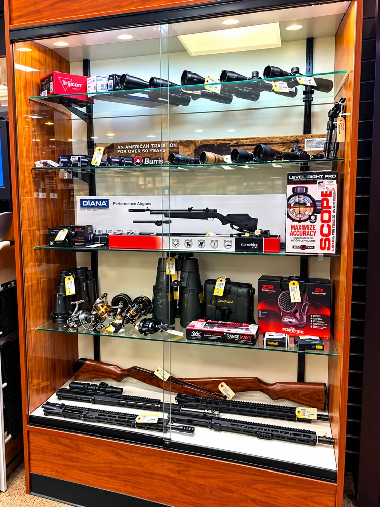 Glass case of rifle scopes, rangefinders and binoculars at Twin Cities Gun & Pawn