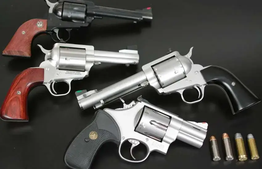 Multiple revolvers on display including single-action and double-action wheelguns